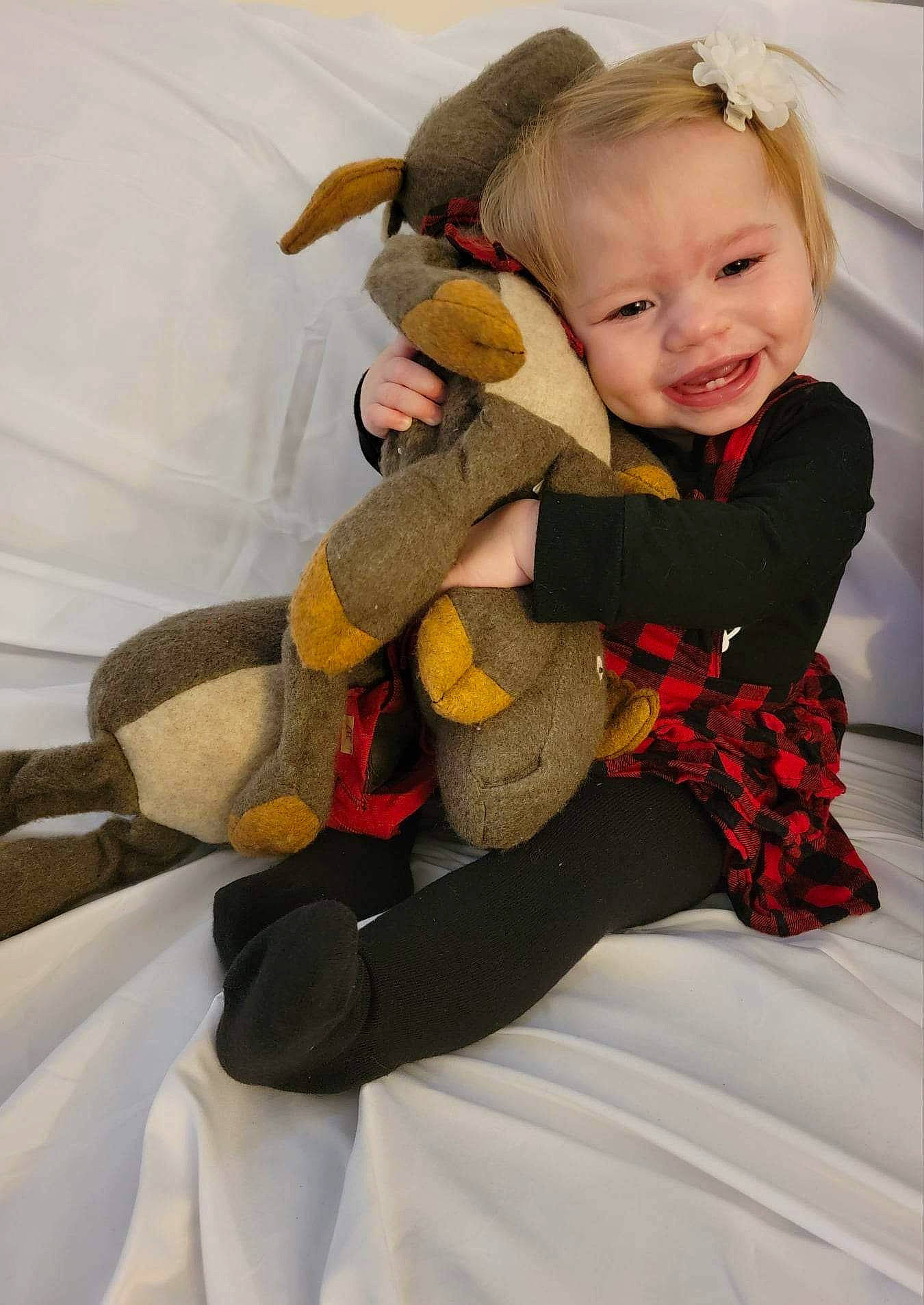 Bonnie is registered to the contest to win money with this photo: arm, baby, baby_toddler_clothing, child, comfort, eye, fun, happy, head, human_body, human_leg, lap, leg, person, skin, sleeve, smile, sock, thigh, toddler