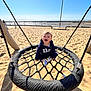 Marceau a rejoint le concours — aidez-le/la à gagner de superbes lots ! child, toddler, swing, playground, beach, sand, smiling, happy, rope, net_swing, hoodie, gap_hoodie, shoes, sunny, ocean, seaside_rail, lamp_post, shadow, play_equipment, cute