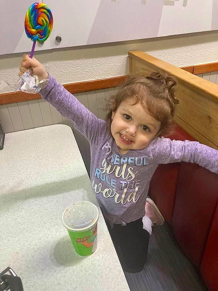 Christina is registered to the contest to win money with this photo: arm, baby_toddler_clothing, chair, child, finger, floor, flooring, fun, happy, hardwood, joy, leisure, person, play, purple, room, smile, standing, t_shirt, table