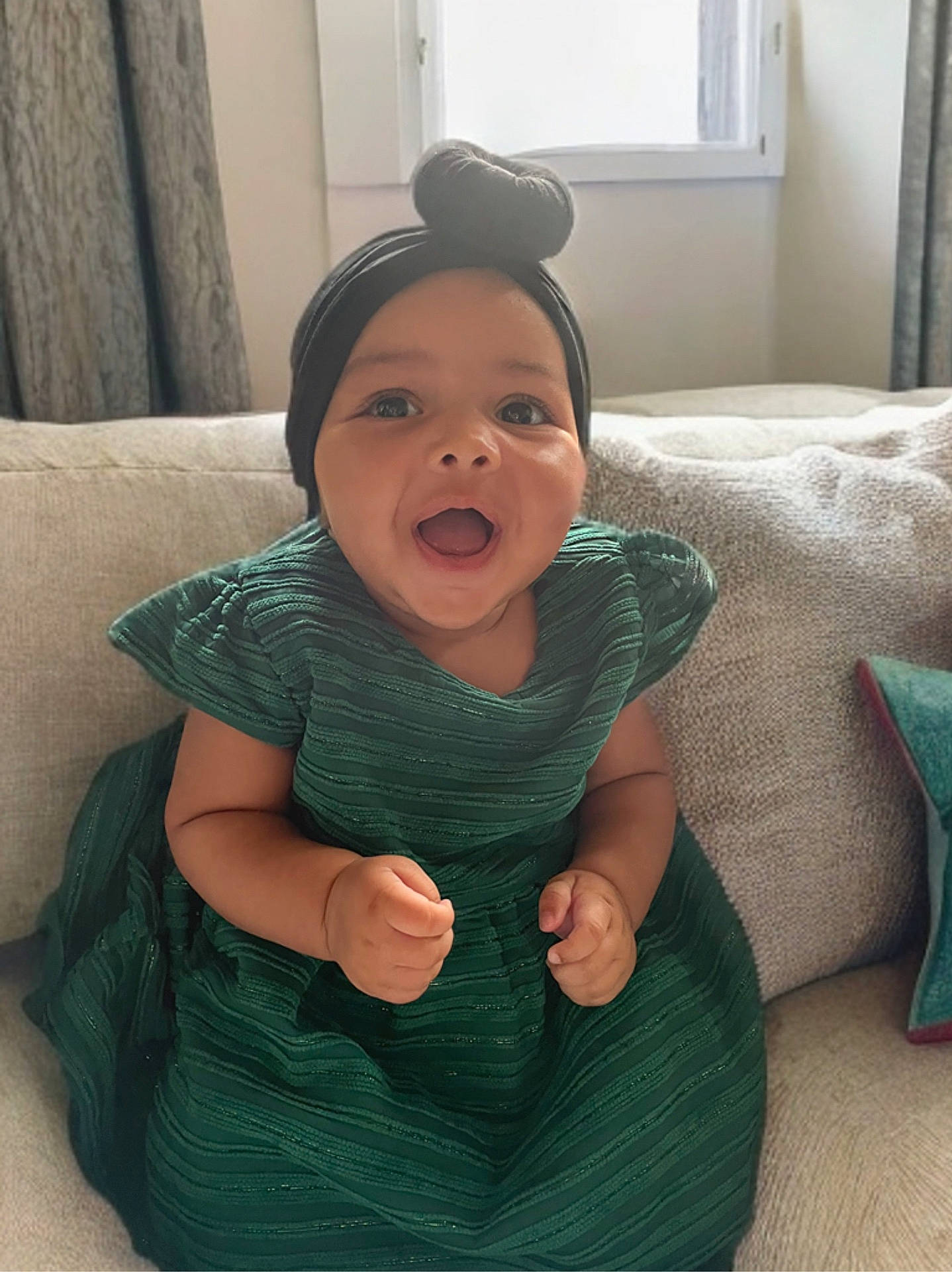 Taelynn is registered to the contest to win money with this photo: baby, babylaughing, bodypart, cap, clothing, couch, cushion, dress, face, finger, furniture, hand, happy, hat, head, homedecor, laughing, person, photography, portrait