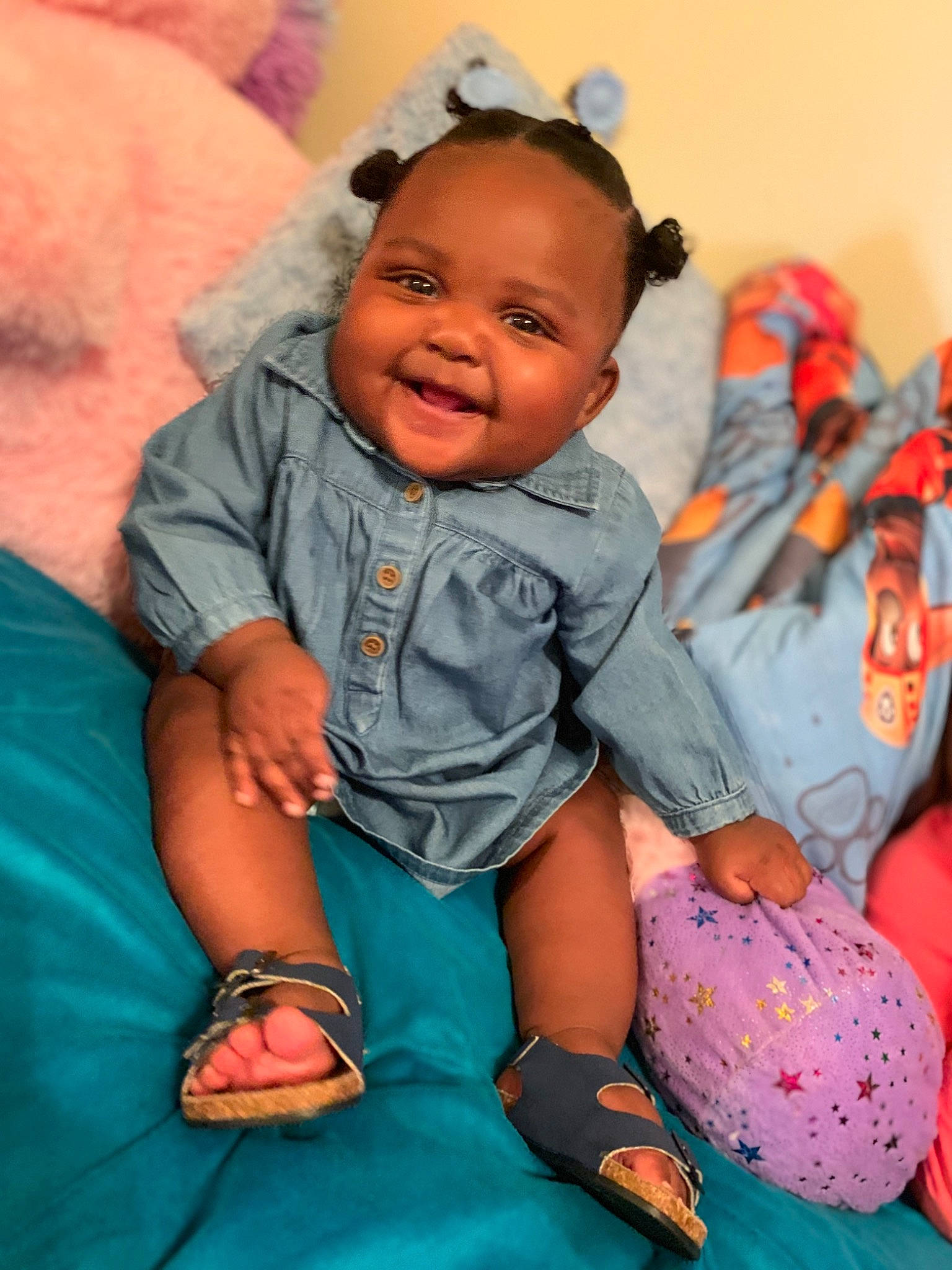 Nyomi is registered to the contest to win money with this photo: baby, baby_products, baby_toddler_clothing, baby_toys, bracelet, cheek, child, ear, hair_accessory, hand, joy, laugh, nail, overall, person, sandal, skin, stuffed_toy, toddler, wrist