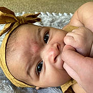 Amirah is registered to the contest to win money with this photo: accessories, baby, bodypart, bonnet, clothing, face, finger, hand, happy, hat, head, headband, jewelry, newborn, person, photography, portrait, smile, wood, wrist