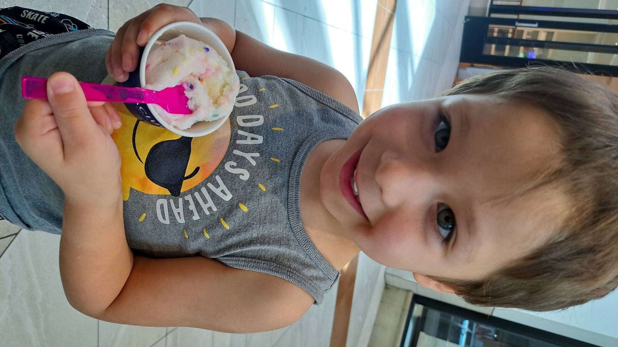 Jayson is registered to the contest to win money with this photo: arm, bookcase, chest, child, elbow, eyelash, fun, happy, joy, lip, mammal, mouth, neck, nose, person, plant, shelf, skin, smile, thigh