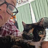 Callie joined the competition — help win amazing prizes! cat, tortoiseshell_cat, pet, animal, face, eyes, whiskers, ears, fur, black_fur, orange_fur, white_fur, portrait, close_up, indoor, home, human, glasses, cuddling, family_photos