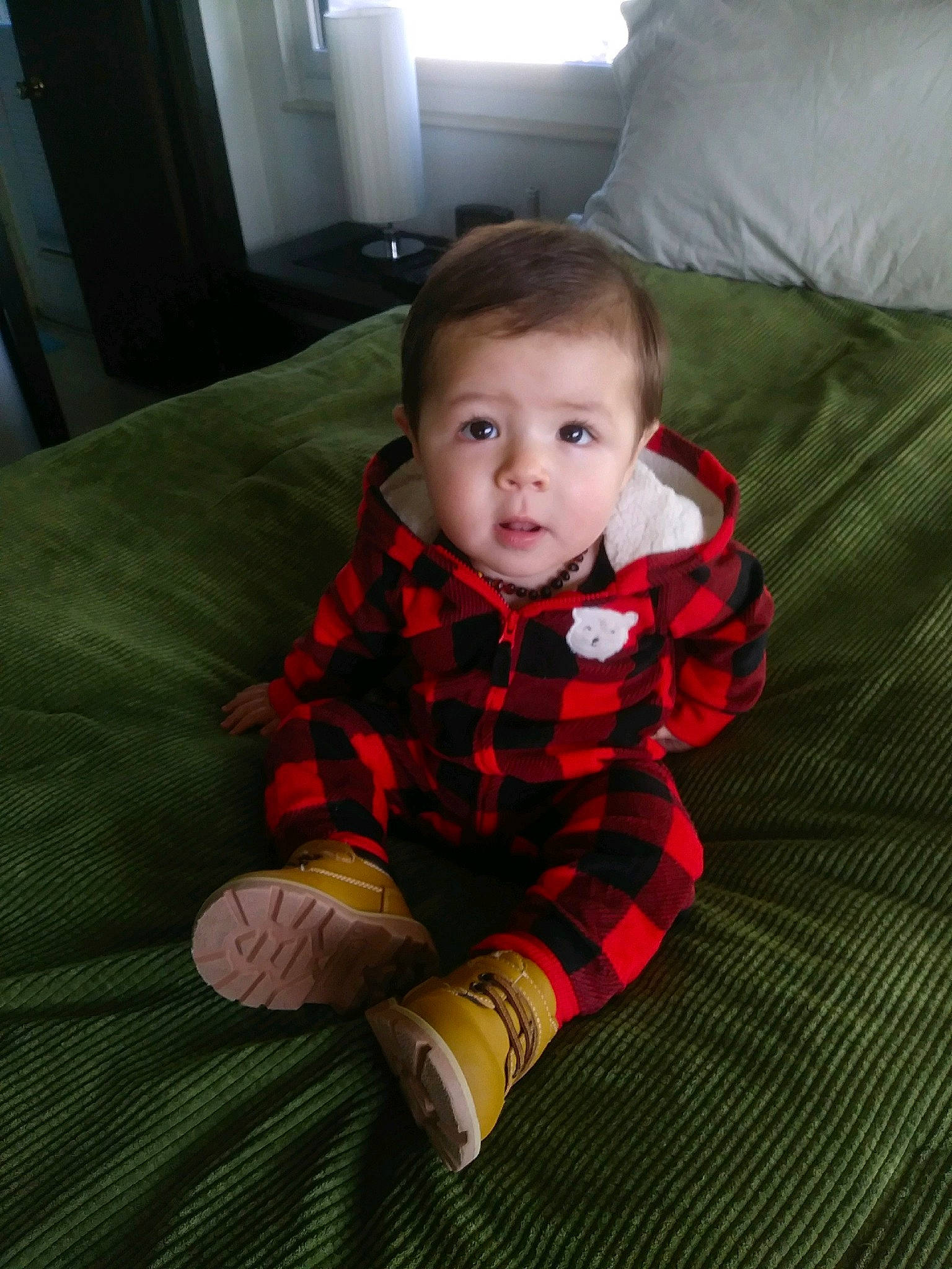 Xavien is registered to the contest to win money with this photo: baby, cheek, child, crawling, design, eye, face, head, pattern, person, plaid, sitting, skin, smile, textile, toddler