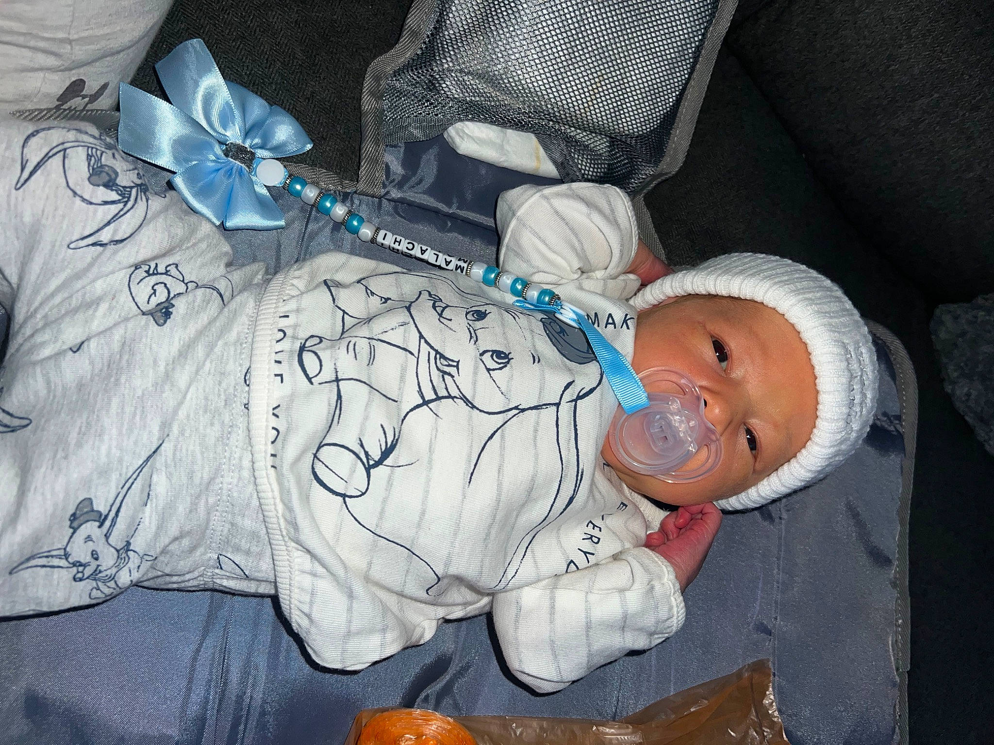 Malachi is registered to the contest to win money with this photo: baby, baby_products, baby_toddler_clothing, calabaza, child, comfort, cucurbita, gourd, hand, hat, headwear, mouth, pattern, person, pumpkin, room, sitting, sleeve, smile, toddler