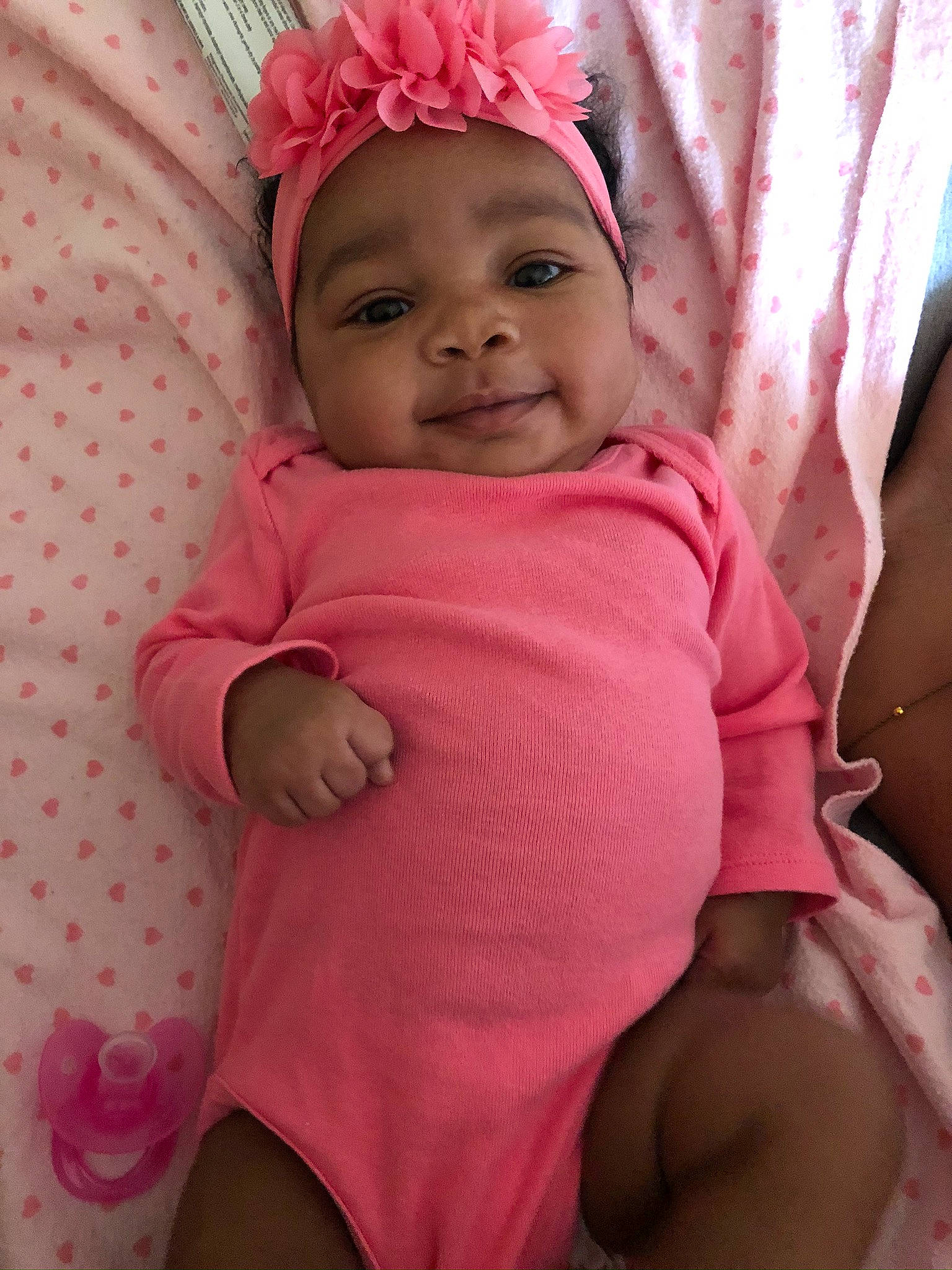 Kyelah is registered to the contest to win money with this photo: baby, baby_products, baby_toddler_clothing, cheek, child, hair_accessory, headgear, headwear, person, pink, product, skin, stomach, toddler