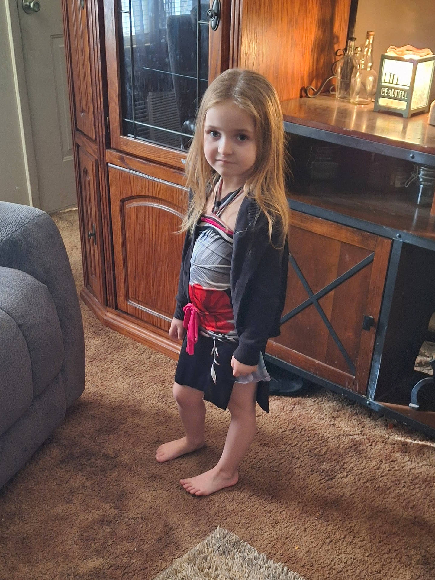 barefoot, cabinet, child, clothing, costume, couch, door, face, female, furniture, girl, head, indoors, interiordesign, pants, person, photography, portrait, shorts, wood