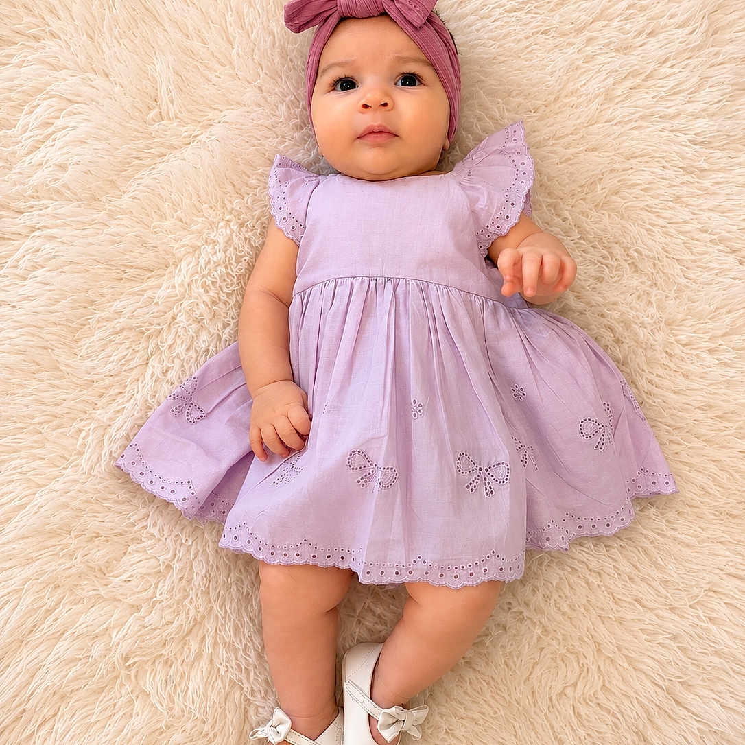 Aisha is registered to the contest to win money with this photo: baby, infant, child, dress, headwrap, bow, shoes, white_shoes, fluffy_rug, purple_dress, cute, lying_down, portrait, indoors, soft_texture, adorable, young_child, fashion, comfortable, happy