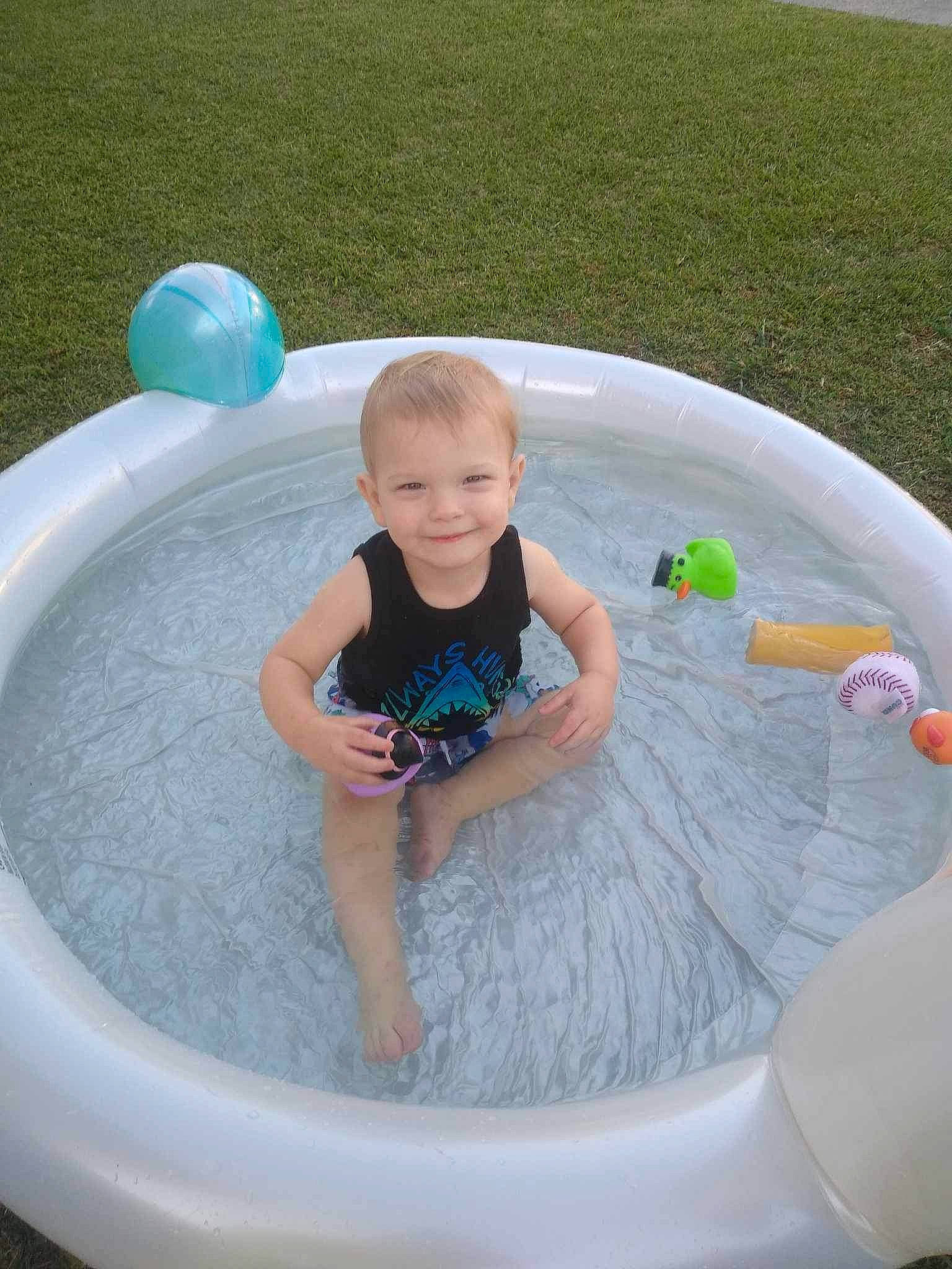 Caleb joined the competition — help win amazing prizes! baby, baby_toddler_clothing, child, circle, composite_material, fun, games, grass, joy, leisure, person, play, recreation, shorts, sitting, smile, t_shirt, toddler, vacation, water