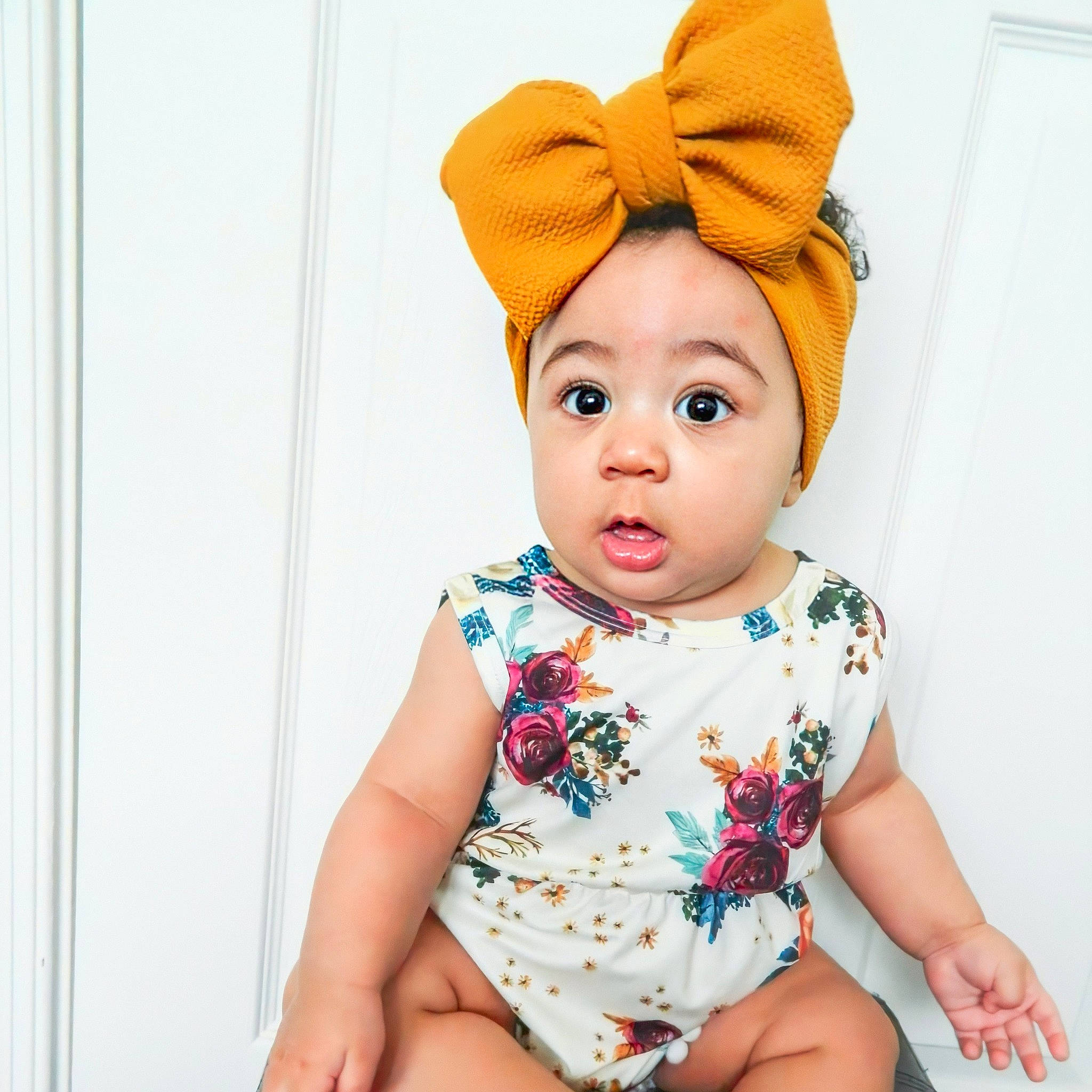 Arabella is registered to the contest to win money with this photo: baby, baby_bloomers, baby_toddler_clothing, beanie, cap, child, child_model, clothing, ear, fashion_accessory, hair_accessory, head, headband, headgear, pattern, person, pink, product, sleeve, surprise