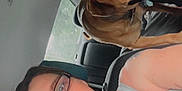 Ike is registered to the contest to win money with this photo: backseat, brown_dog, car_interior, casual_clothing, companion, daylight, dog, glasses, headrest, human, pet, portrait, road, seat, seatbelt, smile, tattoo, vehicle, window, woman
