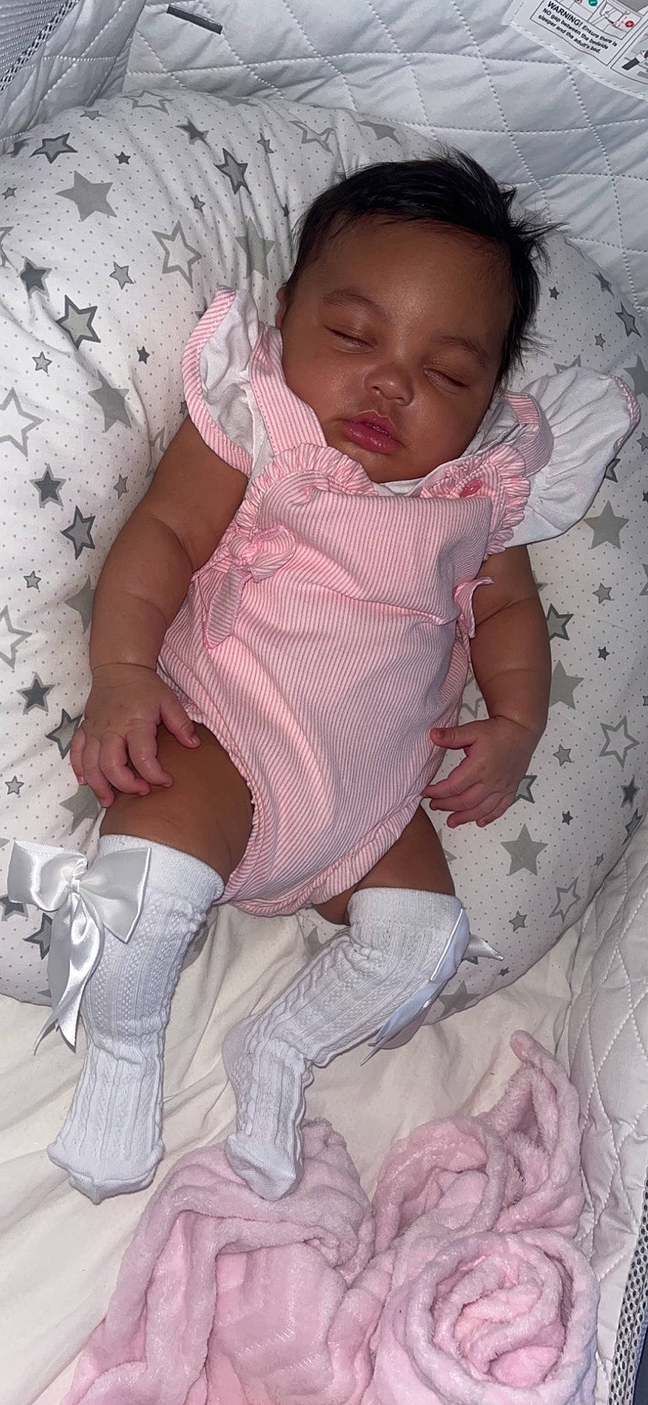 Ivy-jane is registered to the contest to win money with this photo: baby, baby_toddler_clothing, chest, child, comfort, finger, head, human_leg, knee, lap, leg, linens, mouth, pattern, person, pink, skin, sleeve, textile, thigh