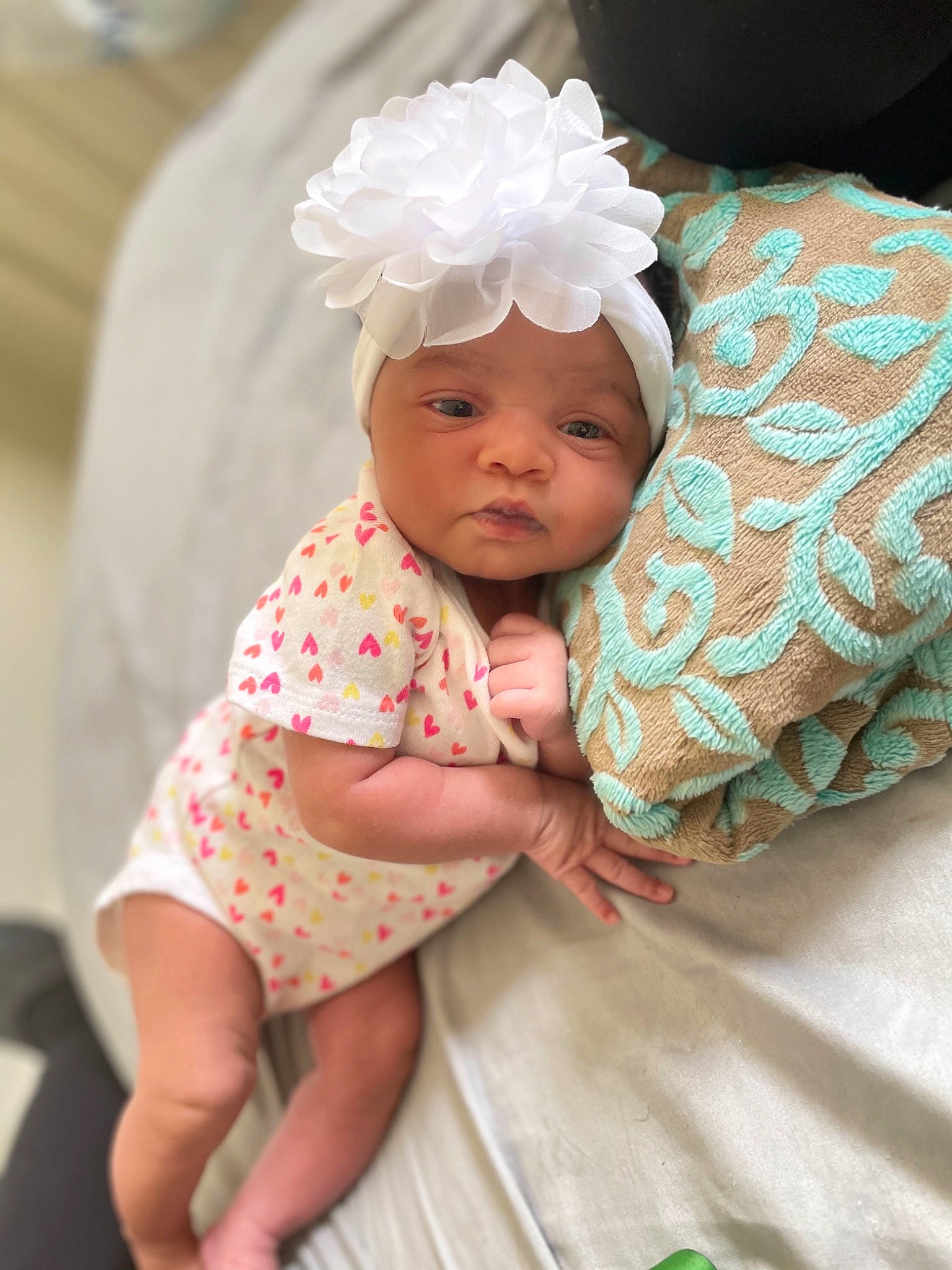 Mulan is registered to the contest to win money with this photo: baby, baby_products, baby_toddler_clothing, cheek, child, chin, comfort, eye, fashion_accessory, finger, grass, green, happy, headwear, linens, peach, person, pink, room, skin