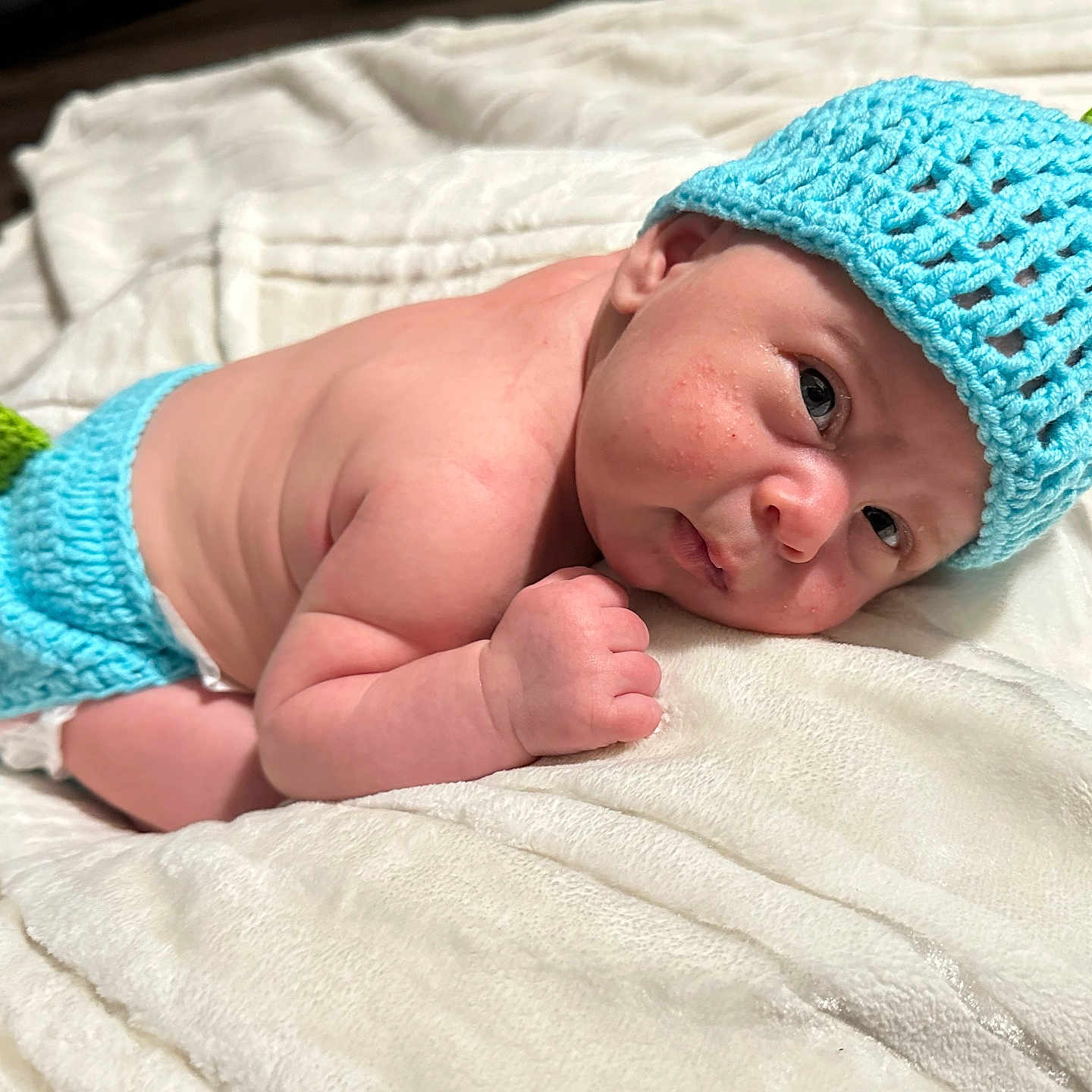 Kaden is registered to the contest to win money with this photo: baby, beanie, blanket, bodypart, bonnet, cap, clothing, face, finger, glove, hand, happy, hat, head, newborn, person, photography, portrait, quilt, smile