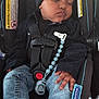 beanie, black_clothing, blue_jeans, car_seat, child, clip, comfort, converse_shoes, corduroy_jacket, cute, denim_jeans, footwear, indoors, infant, nike, pacifier, resting, safety_harness, sleeping, toddler