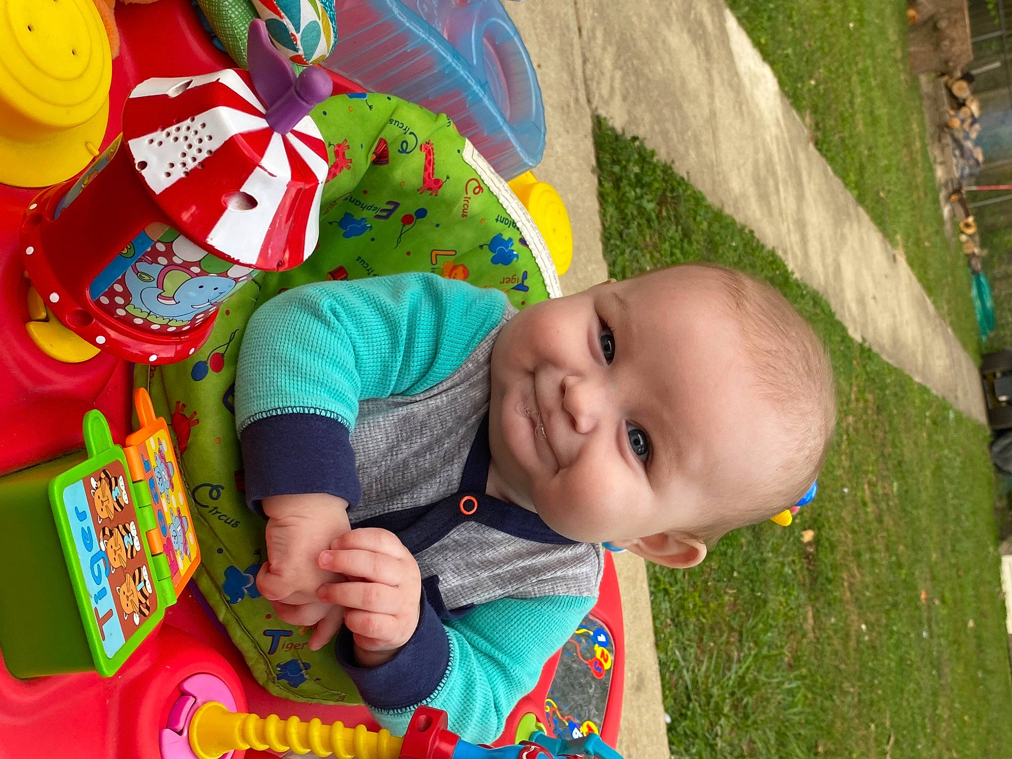 Rayder is registered to the contest to win money with this photo: baby, baby_products, baby_toddler_clothing, cheek, child, fun, grass, green, happy, leisure, people_in_nature, person, plant, play, recreation, sitting, smile, summer, toddler, toy
