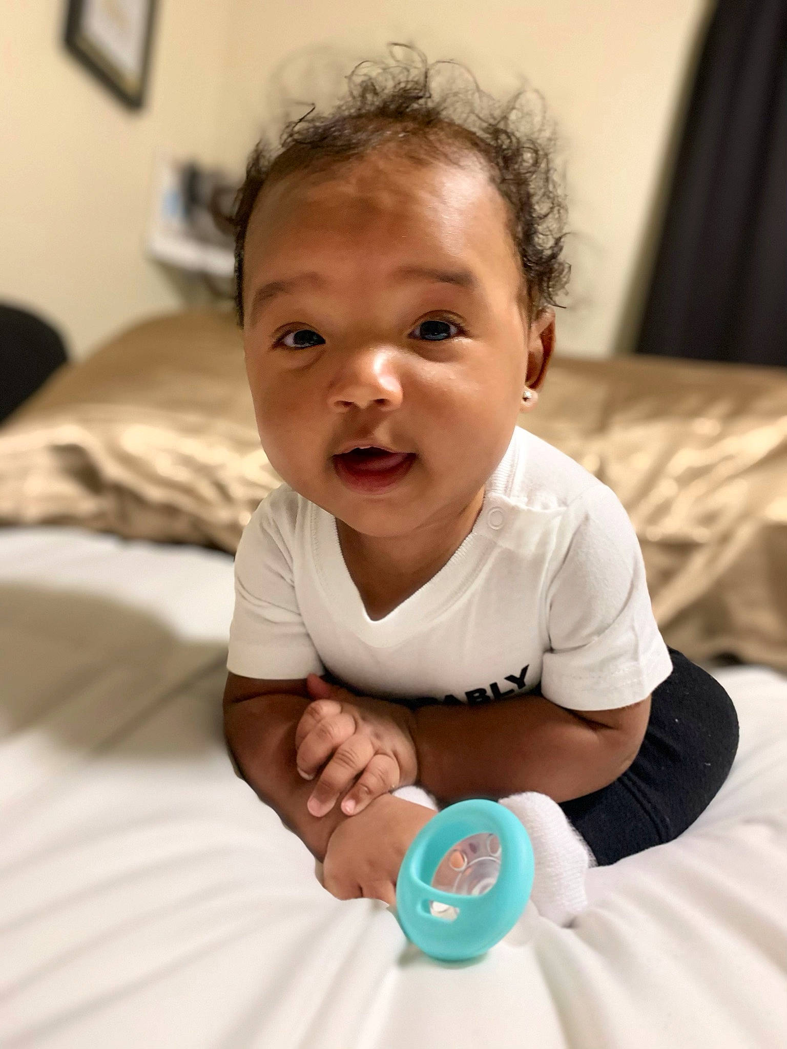 Zyaire is registered to the contest to win money with this photo: baby, baby_toddler_clothing, cheek, child, comfort, elbow, finger, fun, hair, happy, iris, linens, nose, person, room, sitting, skin, sleeve, t_shirt, thumb