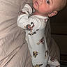 Bodie is registered to the contest to win money with this photo: baby, infant, pajamas, bed, blanket, face, person, child, cute, indoors, sleepwear, lying_down, looking_back, expression, skin, head, eyes, mouth, hand, foot