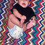 Winona is registered to the contest to win money with this photo: baby, diaper, blanket, colorful, zigzag_pattern, child, cute, hands, feet, expression, wide_eyes, mouth_open, sitting, playful, indoor, portrait, textile, pattern, infant, clothing