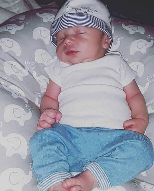 Alexander Klipp is registered to the contest to win money with this photo: baby, baby_toddler_clothing, baseball_cap, cap, cheek, child, comfort, eye, facial_expression, finger, head, headwear, lip, organ, person, pink, product, skin, sleeve, t_shirt