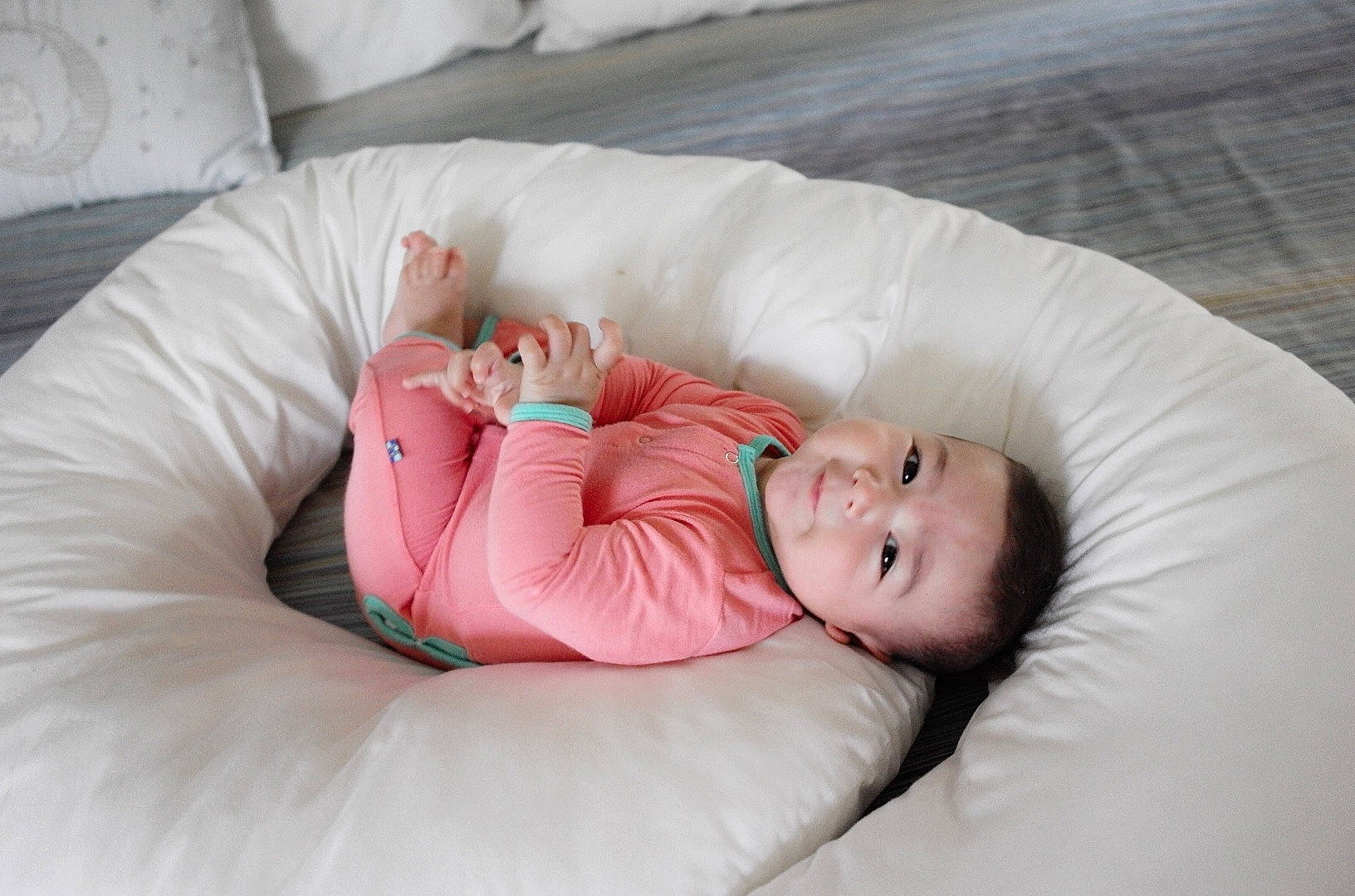 Colette is registered to the contest to win money with this photo: baby, baby_sleeping, baby_toddler_clothing, bedtime, child, comfort, couch, eye, flooring, head, human_body, human_leg, leg, linens, person, pink, product, sitting, skin, throw_pillow