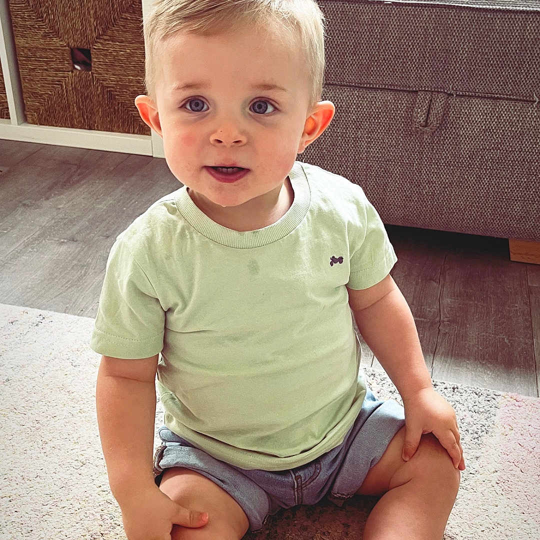 Mason joined the competition — help win amazing prizes! architecture, baby, building, clothing, couch, face, furniture, head, indoors, interiordesign, jeans, livingroom, pants, person, photography, portrait, room, shorts, sitting, t_shirt