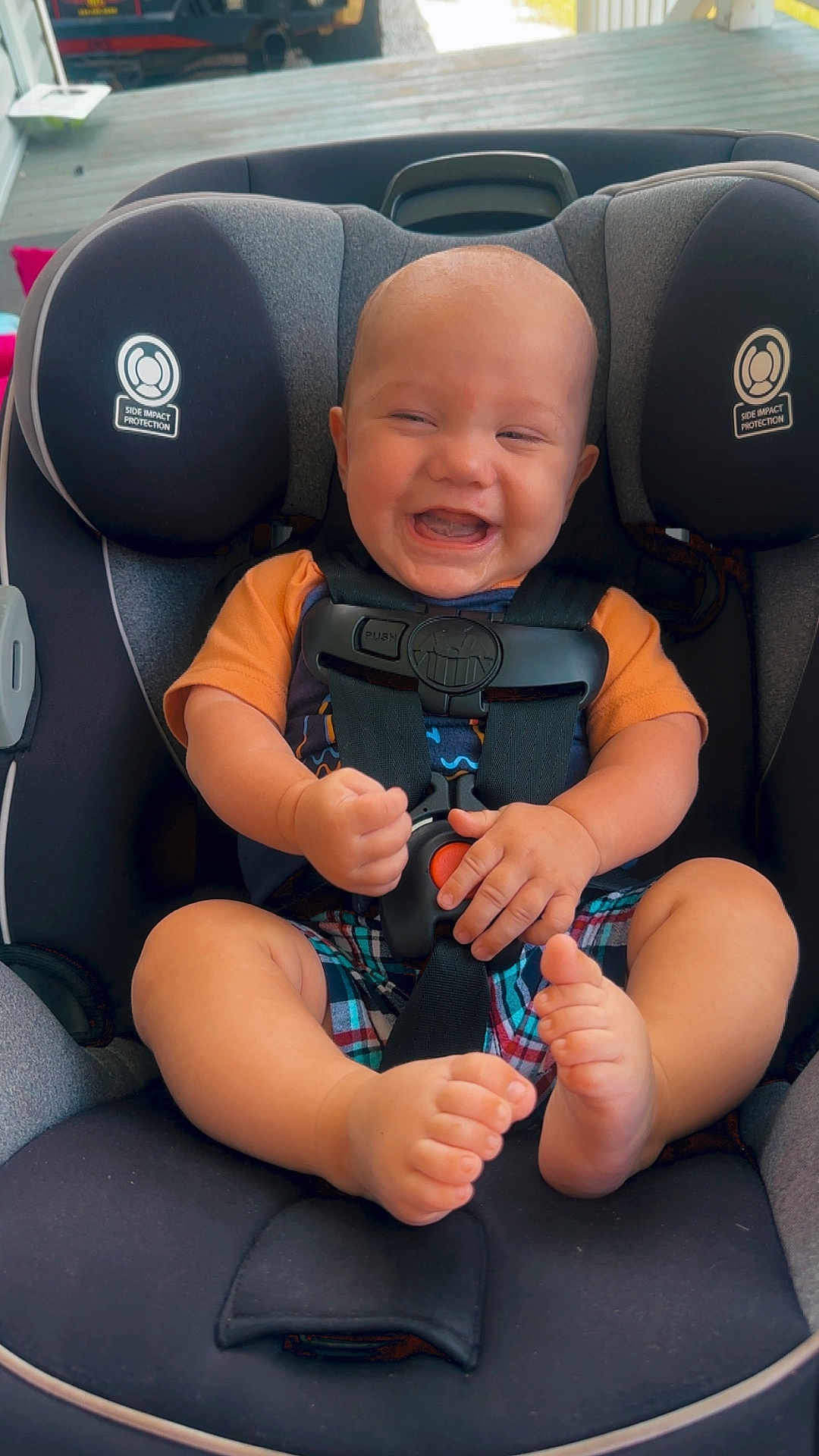 Urijah joined the competition — help win amazing prizes! baby, car_seat, smiling, child, infant, seatbelt, happy, indoors, clothing, plaid_shorts, orange_shirt, barefoot, safety, head, face, hands, feet, seat, protection, child_safety