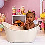 Hazel is registered to the contest to win money with this photo: toddler, child, baby, bathtub, pink_background, hair_bow, curly_hair, indoor, decorations, ice_cream, toy, cute, portrait, sitting, playful, sweet, colorful, young_child, person, fingers