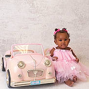 Hazel is registered to the contest to win money with this photo: baby, child, pink_dress, toy_car, indoor, cute, smiling, portrait, girl, tutu, ribbons, curly_hair, footwear_free, sitting, pastel_colors, playful, studio, innocence, small_toy, decor