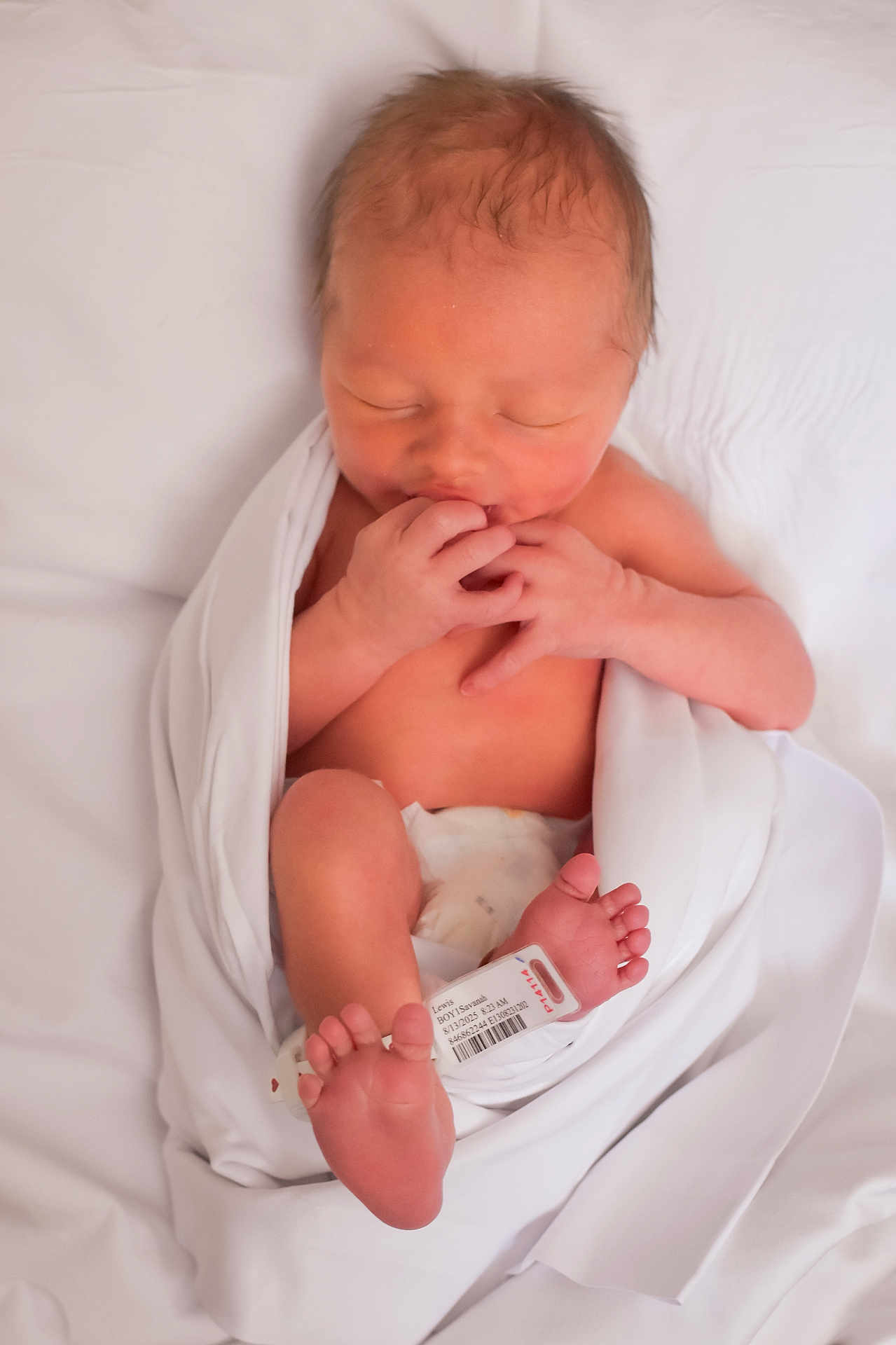 David joined the competition — help win amazing prizes! newborn, baby, infant, blanket, hospital, id_bracelet, sleeping, skin, feet, hands, lying_down, white, soft, peaceful, cute, portrait, human, child, wrapped, resting