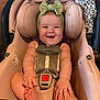 baby, infant, car_seat, smile, headband, green_bow, blanket, leopard_print, happy, child, seatbelt, cute, skin, hand, foot, indoors, person, toddler, sitting, portrait