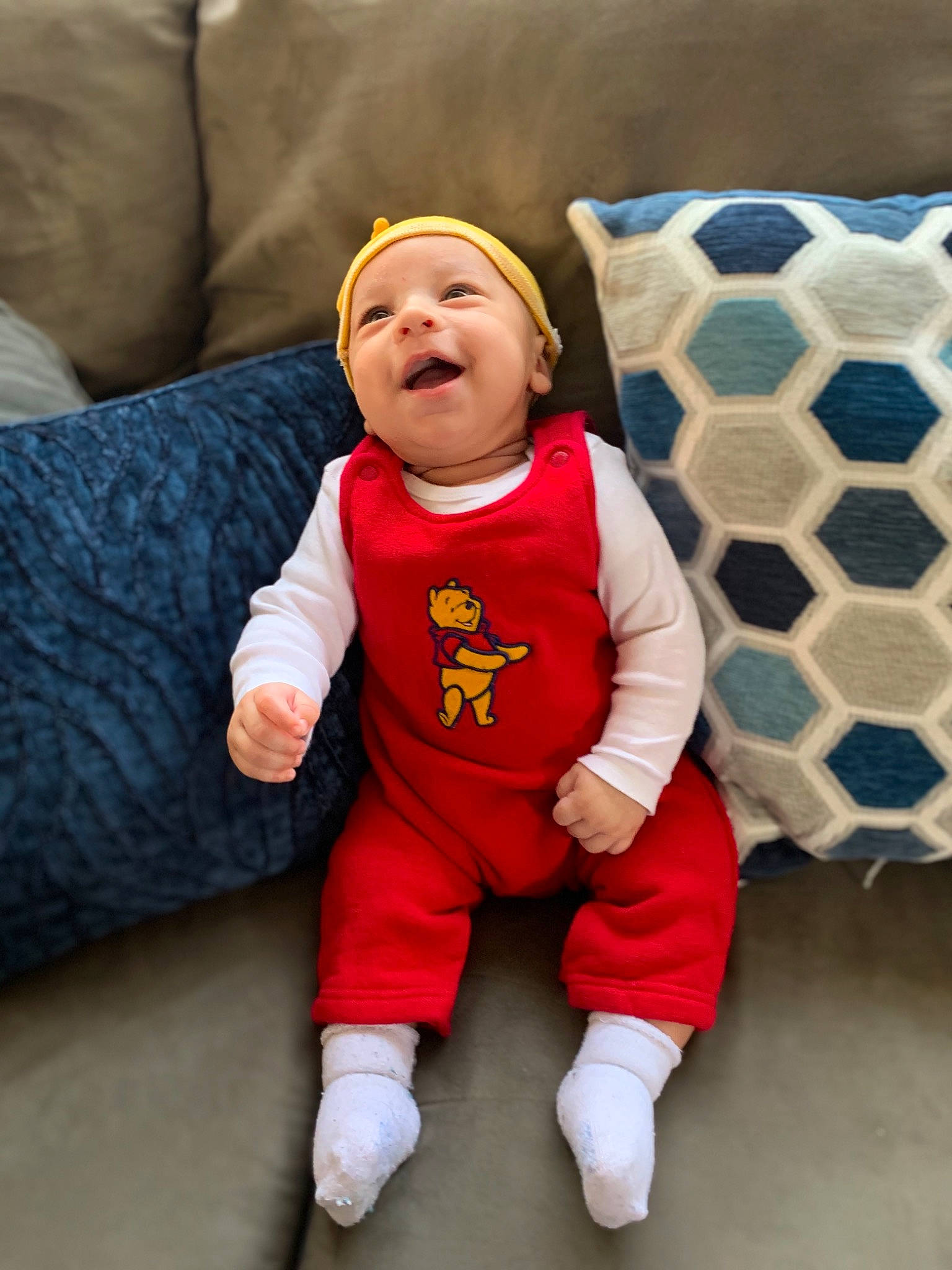 Karmello joined the competition — help win amazing prizes! baby, baby_toddler_clothing, child, comfort, couch, flooring, fun, happy, headwear, linens, pattern, person, pillow, room, sitting, sleeve, smile, sock, t_shirt, textile