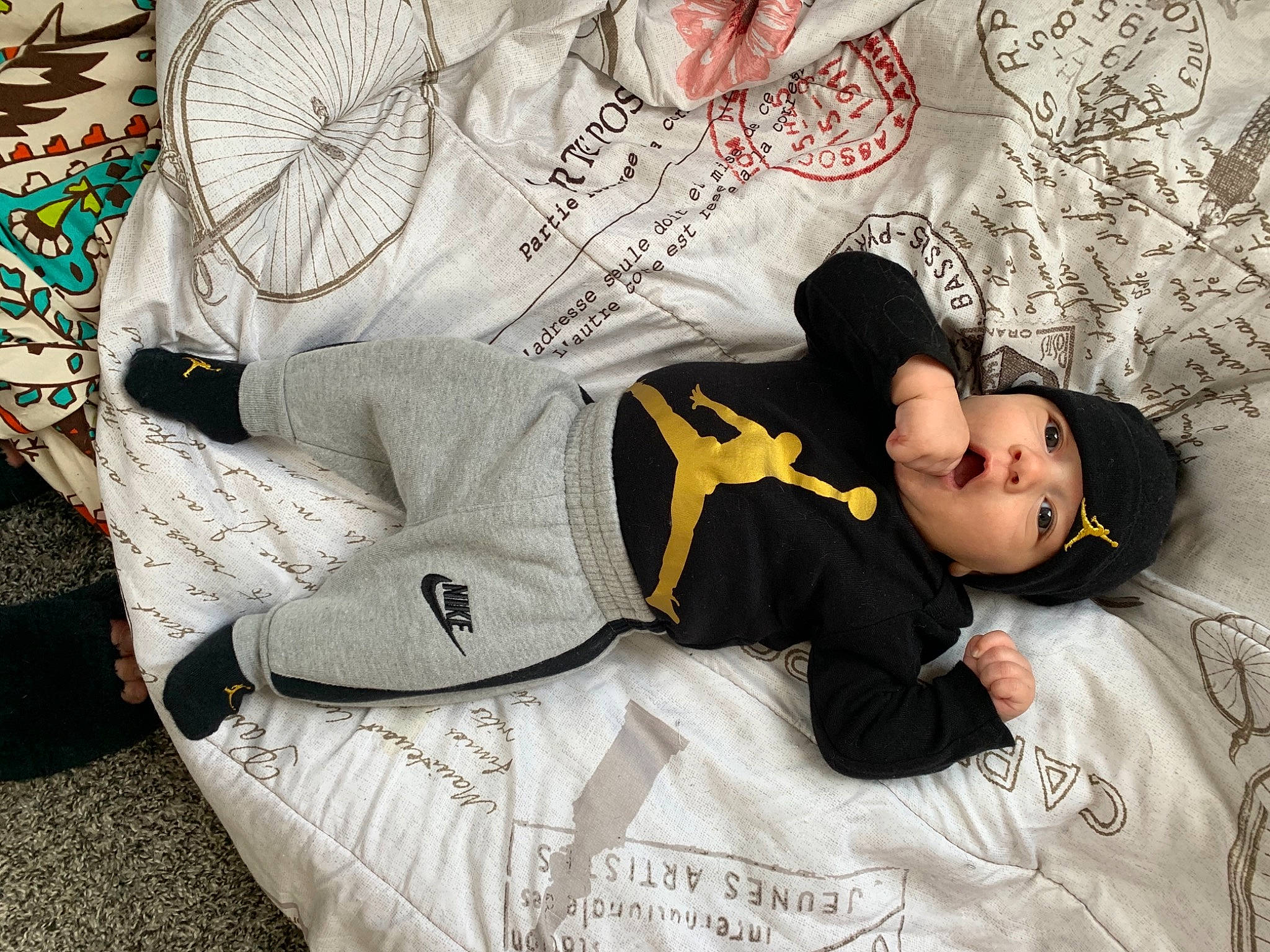 Karmello joined the competition — help win amazing prizes! bed, black_hair, comfort, cool, elbow, facial_expression, font, hairstyle, headwear, human_leg, joint, leg, linens, pattern, person, product, sitting, sleeve, sportswear, t_shirt