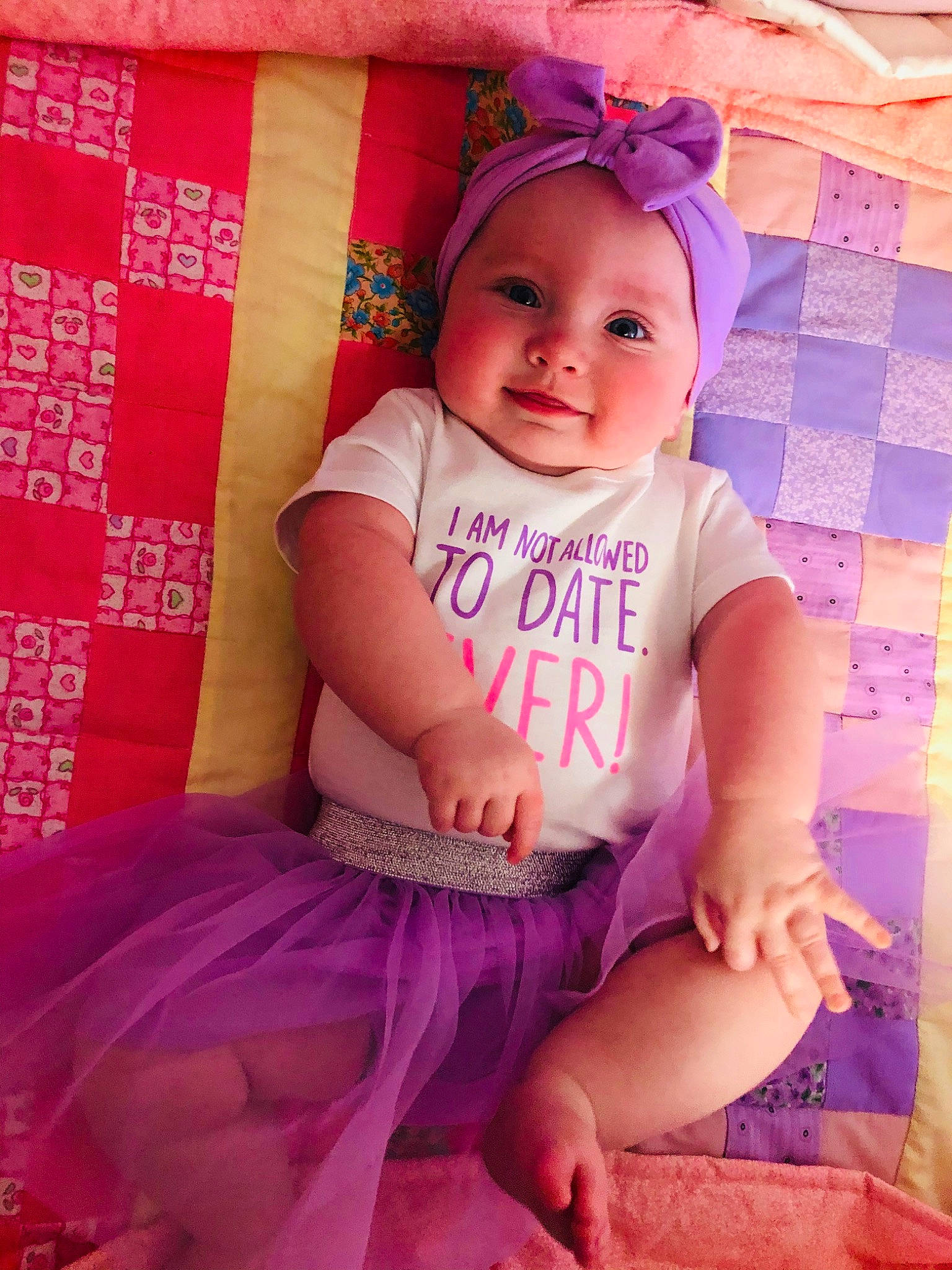 Lilly Farris joined the competition — help win amazing prizes! baby, baby_products, baby_toddler_clothing, child, headwear, magenta, pattern, person, pink, product, purple, smile, textile, toddler