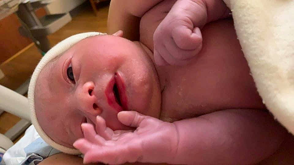 Clay is registered to the contest to win money with this photo: baby, cheek, chest, ear, eye, eyebrow, eyelash, finger, gesture, hand, head, human_body, lip, mouth, nail, neck, nose, person, skin, thumb