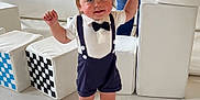Beau joined the competition — help win amazing prizes! adult, baby, bow_tie, checkered_pattern, child, cute, floor_mat, happy, holding_hand, indoor, light, person, play_area, shorts, smiling, soft_blocks, suspenders, toddler, walking, white_socks