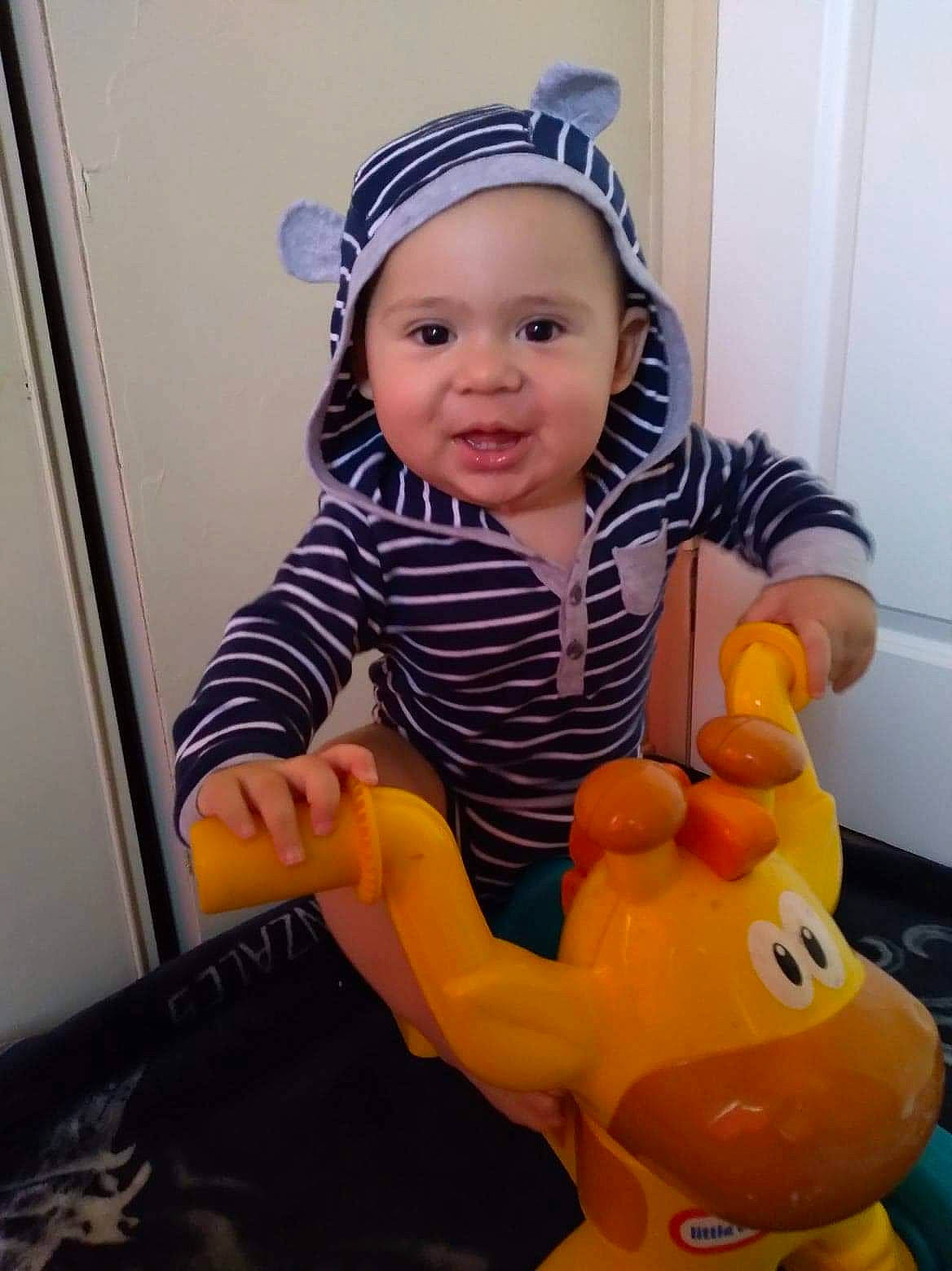 Leandro joined the competition — help win amazing prizes! baby, child, finger, headwear, person, play, smile, thumb, toddler, toy, yellow