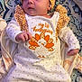 baby, infant, child, thanksgiving, holiday_outfit, headband, bow, blanket, patterned_blanket, cute_clothing, orange, white_outfit, polka_dots, laying_down, indoors, portrait, small_hands, soft_fabric, baby_girl, sleepwear