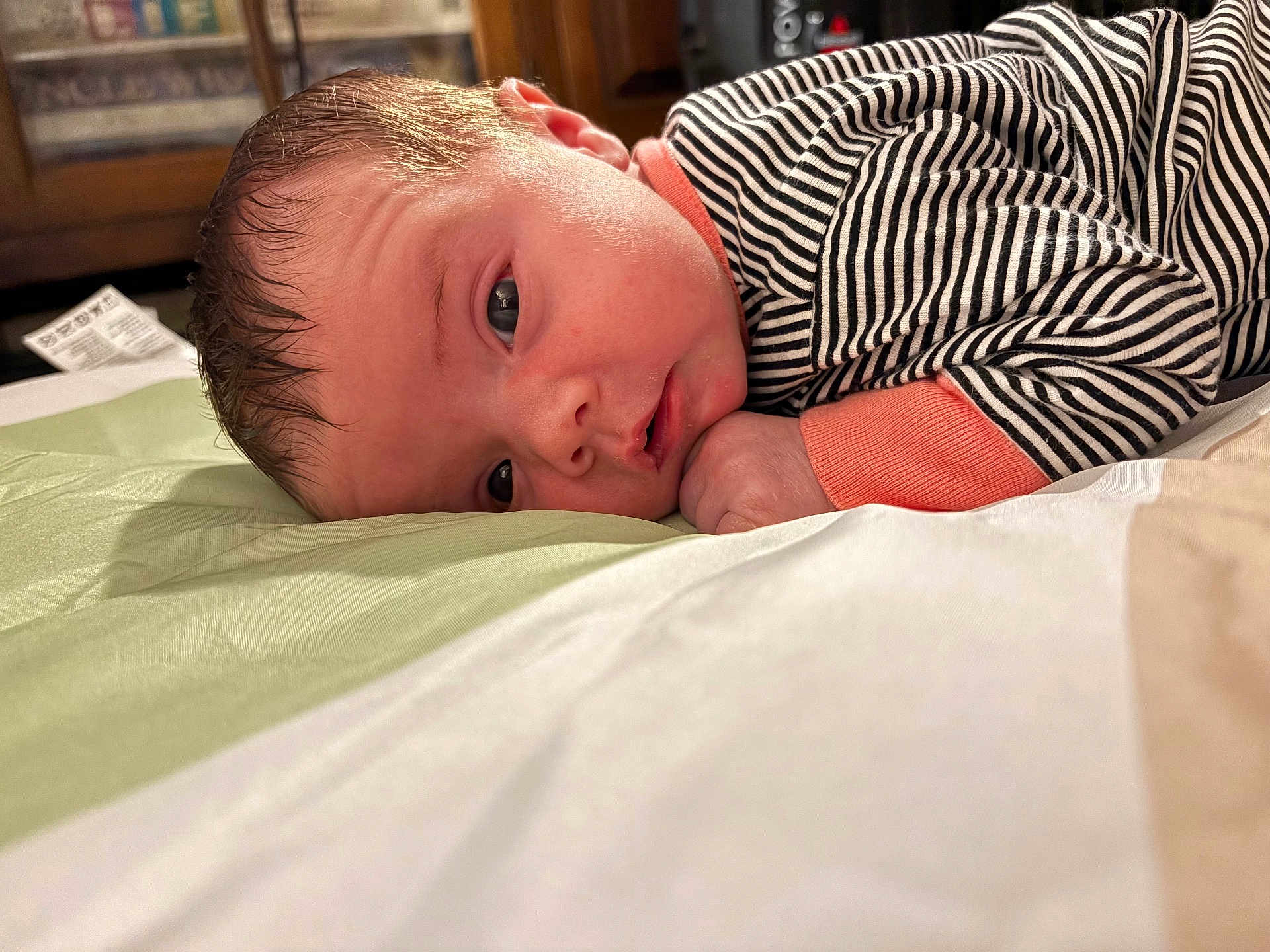 Catherine joined the competition — help win amazing prizes! baby, infant, face, closeup, lying_down, pajamas, striped_clothing, hand, bed, blanket, sleepy, indoors, resting, young_child, cute, portrait, skin, head, expression, comfort