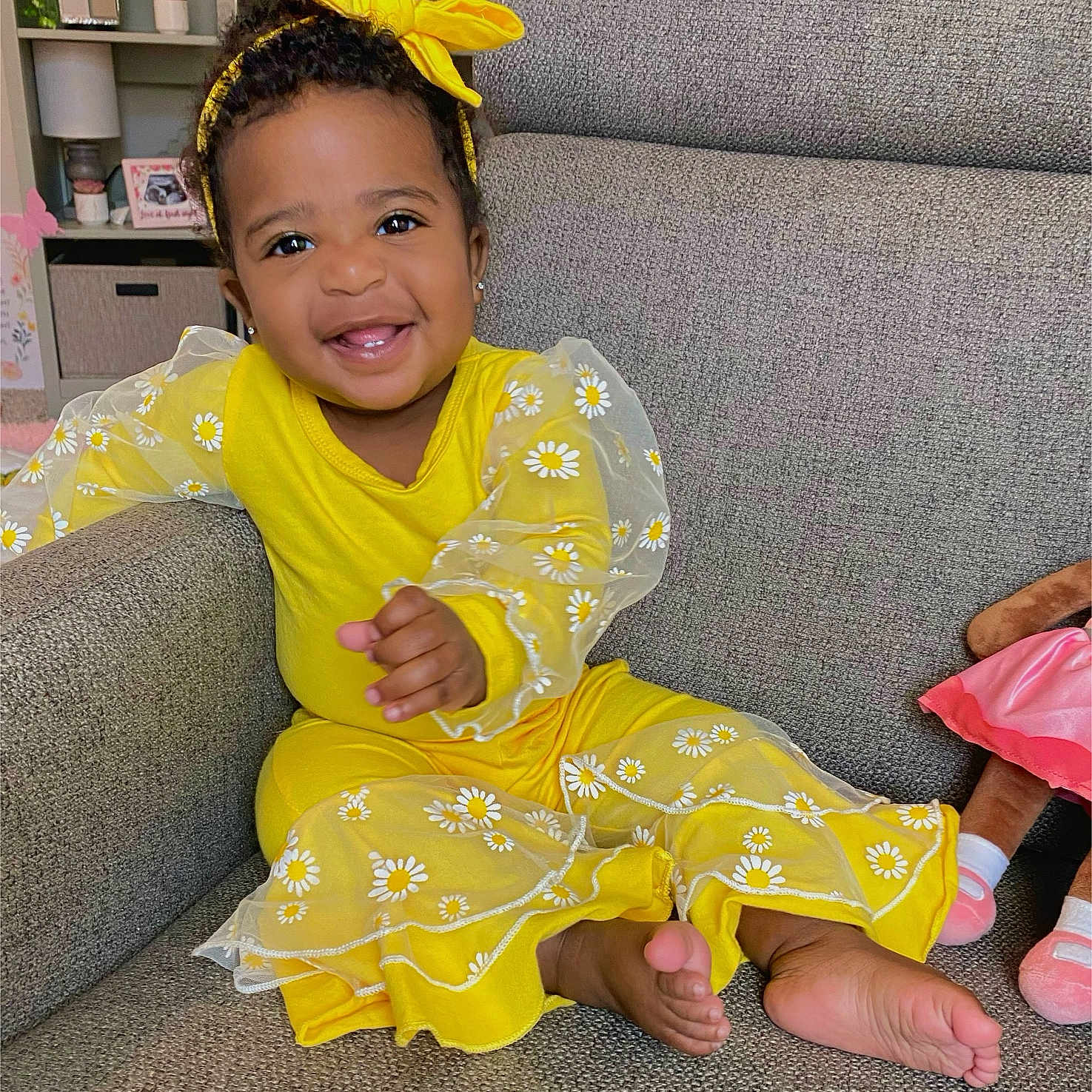 Zaveah is registered to the contest to win money with this photo: baby, bodypart, clothing, coat, couch, cushion, dress, face, finger, furniture, hand, happy, head, homedecor, person, photoframe, photography, portrait, sitting, smile