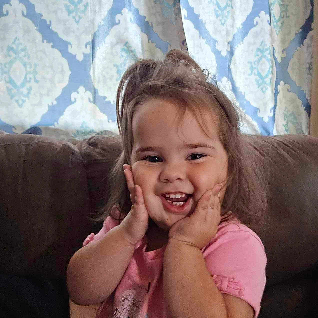 Aliliana is registered to the contest to win money with this photo: bodypart, child, couch, cushion, face, female, finger, furniture, girl, hand, happy, head, homedecor, laughing, mouth, person, photography, portrait, smile, teeth
