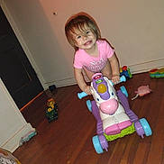 Aspen joined the competition — help win amazing prizes! child, toddler, toy, ride_on_toy, smile, indoor, wooden_floor, pink_clothing, happy, playtime, colorful, plastic_toy, floor_toys, young_child, person, baby_toy, cute, fun, childhood, room