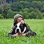 boy, child, dog, pet, grass, field, hoodie, outdoor, nature, greenery, animal, friendship, cute, portrait, relaxing, summer, casual, companion, lying_down, calm