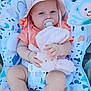baby, child, pacifier, hat, plush_toy, bunny, seat, patterned_fabric, infant, clothing, cute, blue_eyes, barefoot, orange_shirt, bracelet, toy, baby_seat, indoor, comfort, person