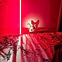 animal, bed, blanket, cozy, curious, dog, ear, furniture, indoor, lamp, lighting, marble_pattern, night, peek, pet, portrait, red_light, room, shadow, wall