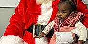 Aunystee Star joined the competition — help win amazing prizes! santa_claus, child, toddler, holiday, christmas, red_clothing, white_gloves, beard, indoor, seated, black_hair, braids, vest, pants, socks, watch, person, face, portrait, festive