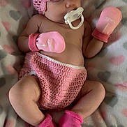 Chrissy is registered to the contest to win money with this photo: adorable, baby, blanket, child, cozy, crocheted_diaper_cover, crocheted_hat, cute, heart_pattern, indoor, infant, mittens, pacifier, peaceful, pink, portrait, resting, sleeping, socks, soft_texture