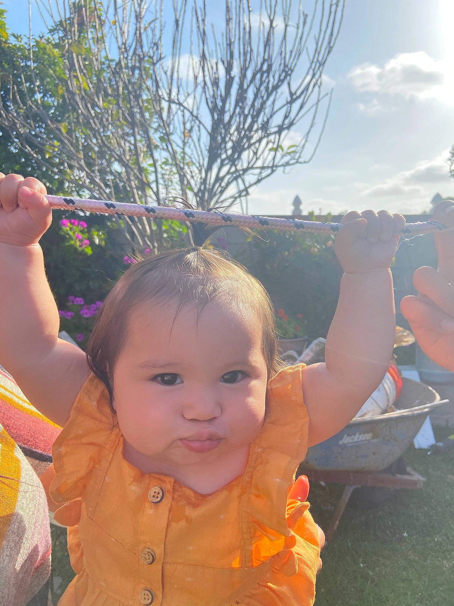 Alison is registered to the contest to win money with this photo: baby_toddler_clothing, botany, cloud, cool, finger, gesture, grass, happy, iris, leaf, leisure, people_in_nature, person, plant, skin, sky, smile, summer, thumb, toddler