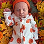 Easton joined the competition — help win amazing prizes! baby, infant, sleeping, autumn, fall_leaves, orange_hat, pumpkin_pattern, onesie, child, cozy, nature, seasonal, cute, peaceful, portrait, closeup, skin, hand, laying_down, soft_texture